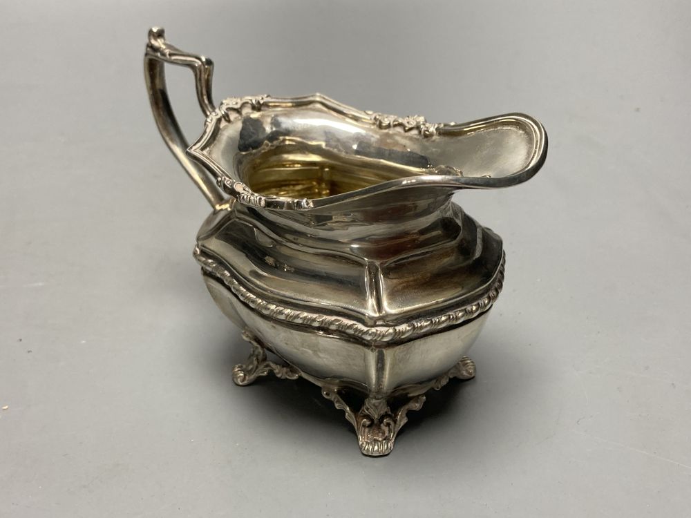 A George V silver bachelors three piece tea set, Josiah Williams & Co, London, 1913 and a silver pickle fork,
